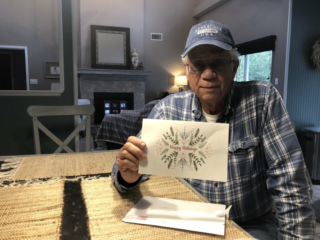 Michael Esmond holding greeting card