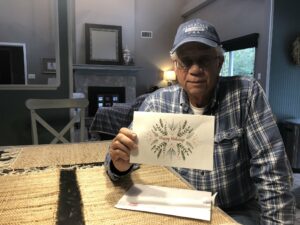 Michael Esmond holding greeting card