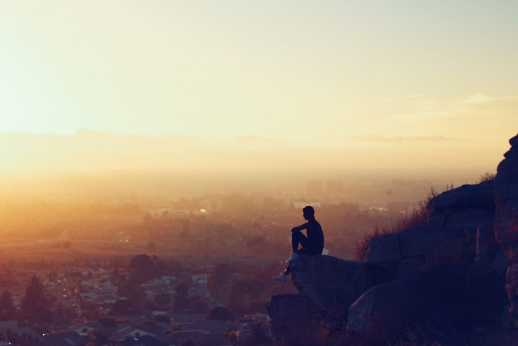 Image of person sitting alone above city