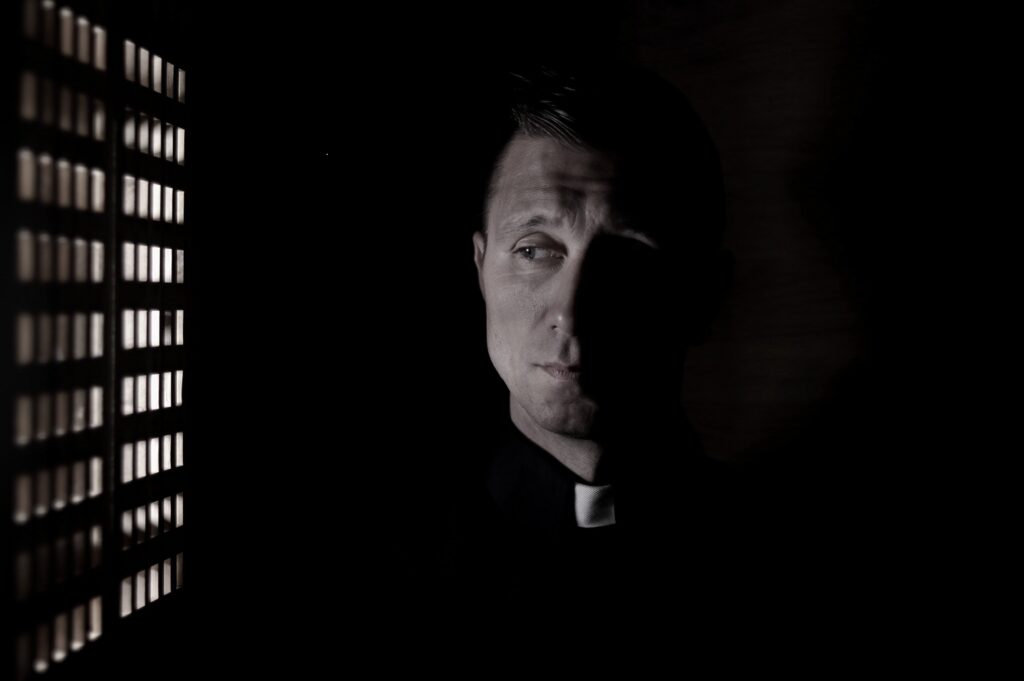 Image of priest in confessional