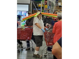 Image of man in store with crown of pool noodles