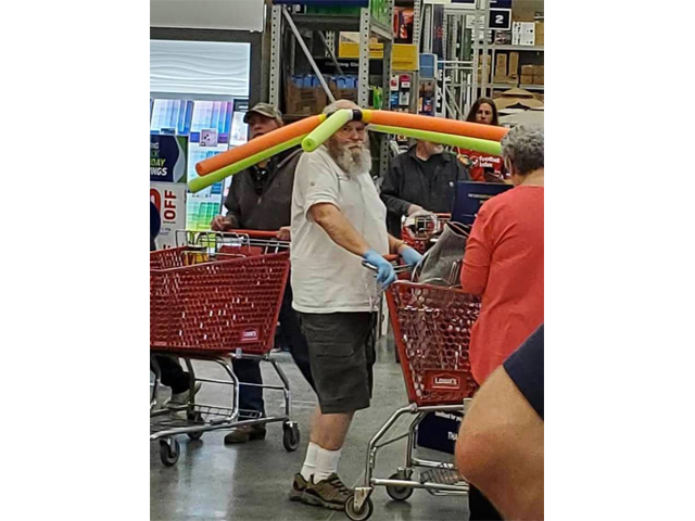 Image of man in store with crown of pool noodles