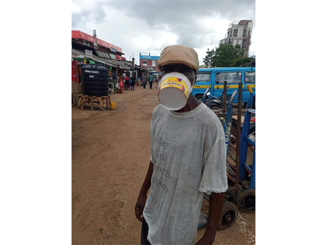 Image of man wearing ice cream carton as mask