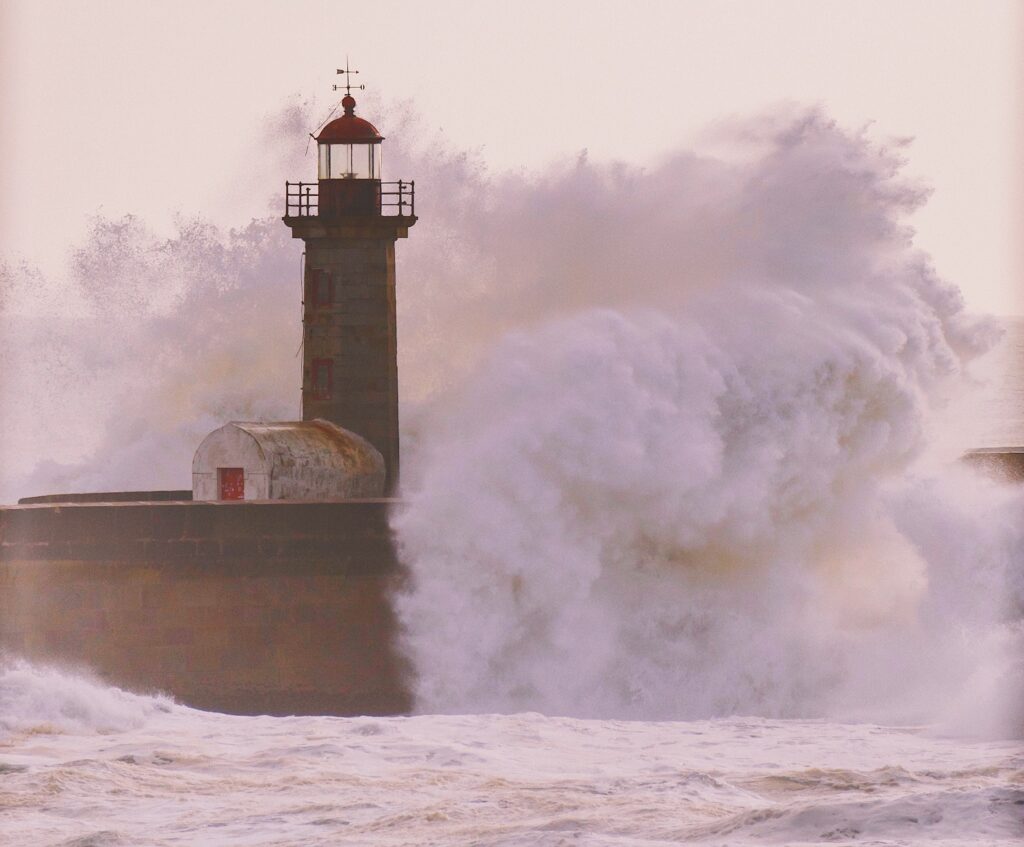 Image of lighthouse battered by wave