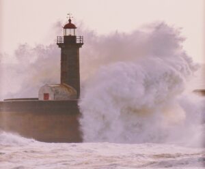 Image of lighthouse battered by wave