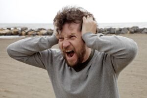 Image of angry man pulling his hair