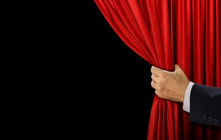 Man pulling open theater curtain