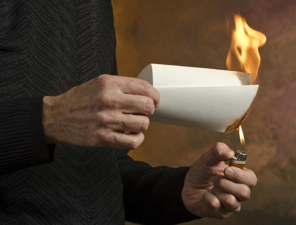 Image of man burning document