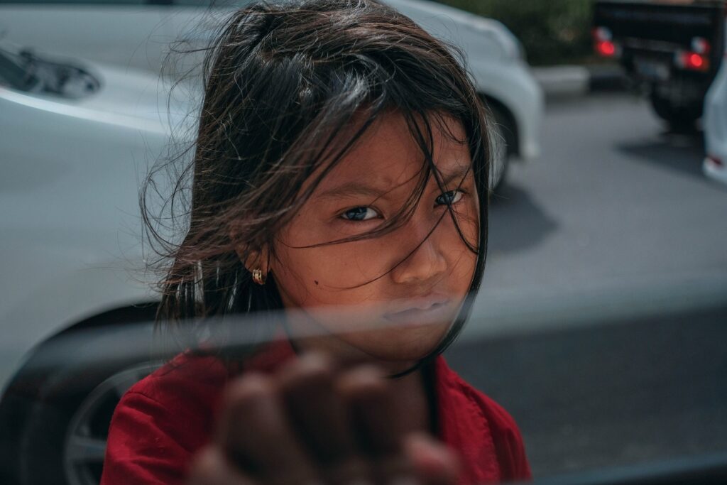 Image of girl standing next to open car window