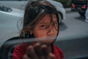 Image of girl standing next to open car window