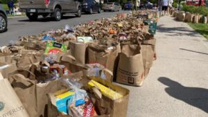 Image of bags of groceries lining street