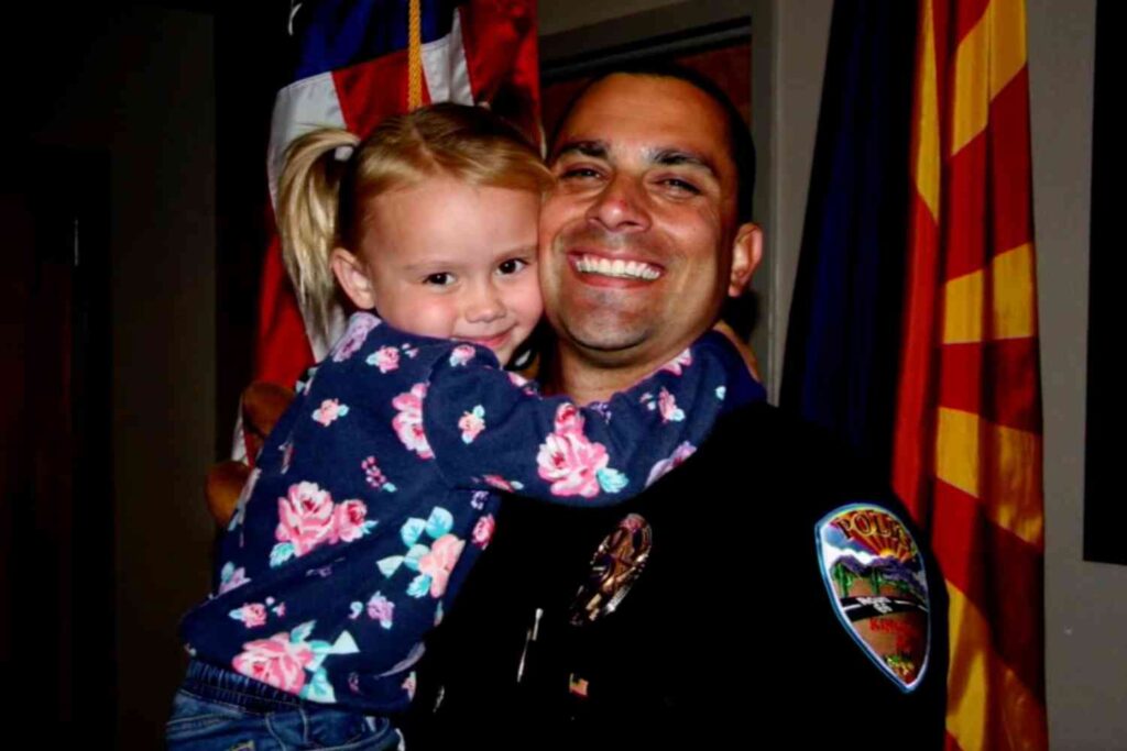 Police officer Brian Zach hugs his newly-adopted daughter