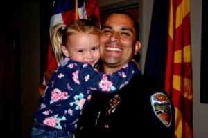 Police officer Brian Zach hugs his newly-adopted daughter