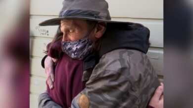 Image of tween girl hugging a homeless man