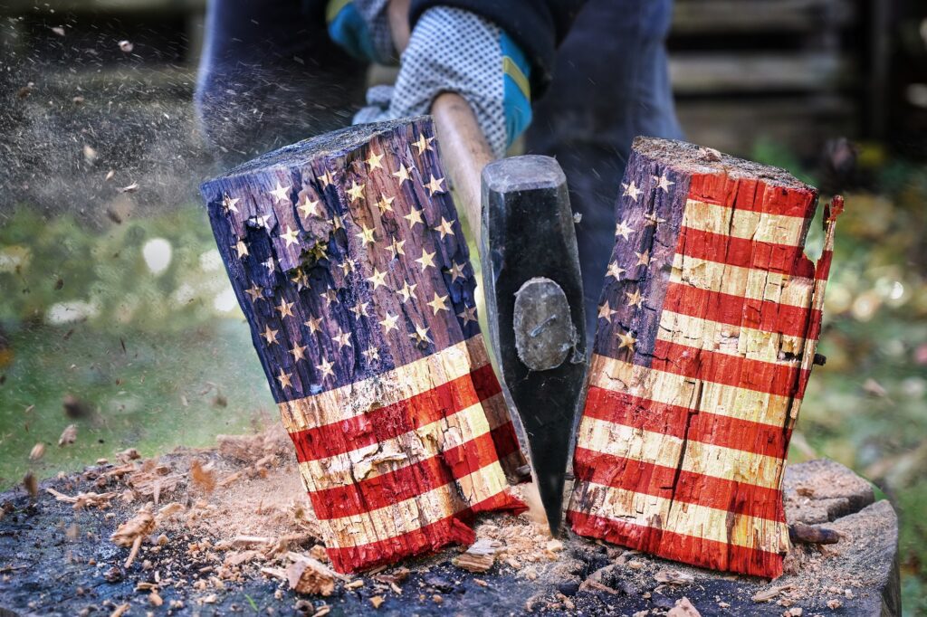 Image of axe splitting flag-colored wood