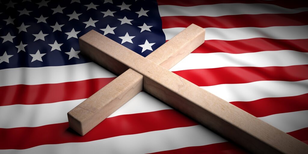 Picture of wooden cross on American flag