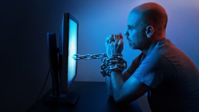 Image of man chained to a computer screen