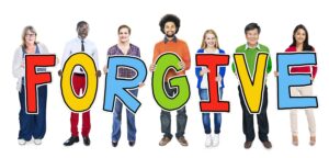 Image of group of people spelling the word FORGIVE
