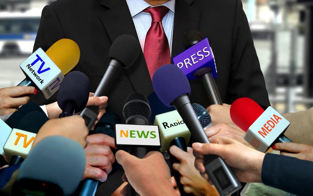 Image of microphones at a press conference