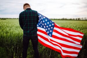 Image of a grateful man holding an American flag