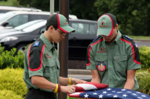 Image of Trail Life members folding a flag