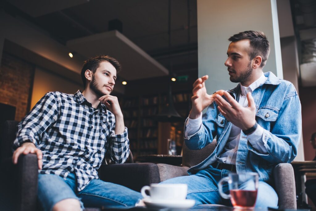 Image of two men engaged in serious discussion.